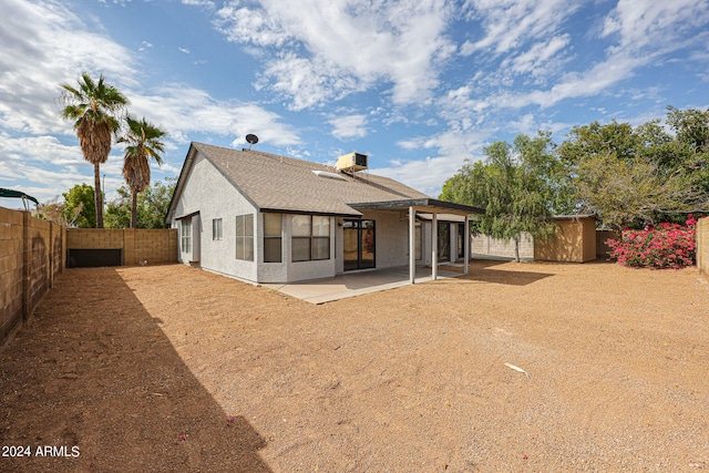 back of property with a patio