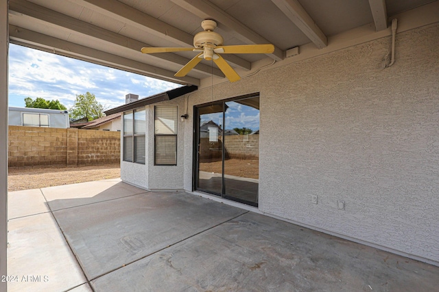 view of patio with fence and a ceiling fan