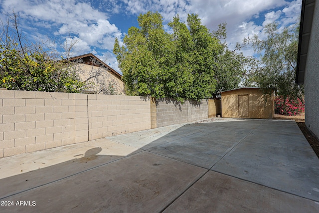 view of patio featuring a shed