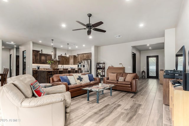 22050 W El Grande Trl, Wickenburg, AZ 85390 - living room featuring light wood-style flooring, a ceiling fan, visible vents, and recessed lighting
