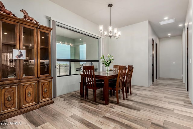22050 W El Grande Trl, Wickenburg, AZ 85390 - dining space with light wood-style floors and an inviting chandelier