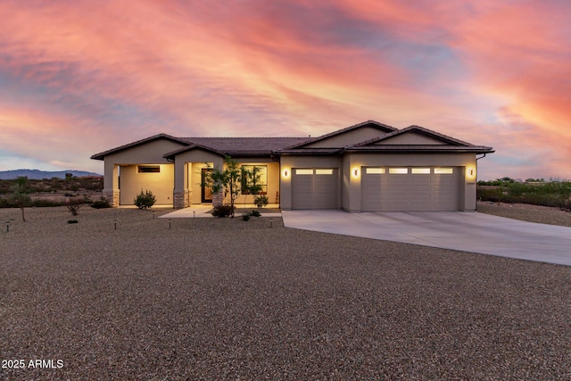 22050 W El Grande Trl, Wickenburg, AZ 85390 - single story home featuring a tiled roof, an attached garage, stucco siding, and concrete driveway