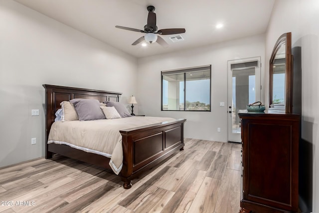 22050 W El Grande Trl, Wickenburg, AZ 85390 - bedroom featuring access to outside, light wood-type flooring, ceiling fan, and visible vents