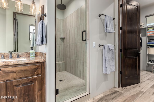 22050 W El Grande Trl, Wickenburg, AZ 85390 - bathroom with a stall shower, wood finished floors, and vanity