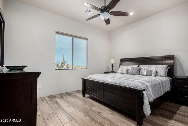 22050 W El Grande Trl, Wickenburg, AZ 85390 - bedroom featuring light wood-style flooring, a ceiling fan, and visible vents
