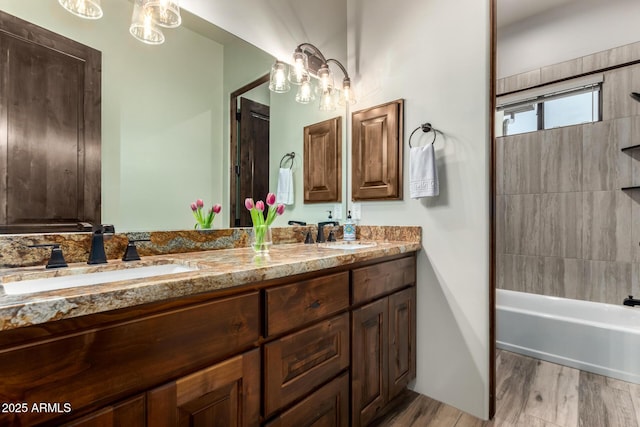 22050 W El Grande Trl, Wickenburg, AZ 85390 - bathroom featuring shower / bath combination, double vanity, a sink, and wood finished floors