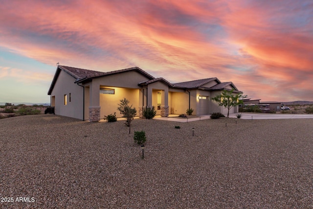 22050 W El Grande Trl, Wickenburg, AZ 85390 - ranch-style house with a tiled roof, a garage, stucco siding, and driveway