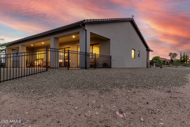 22050 W El Grande Trl, Wickenburg, AZ 85390 - rear view of property featuring stucco siding and fence