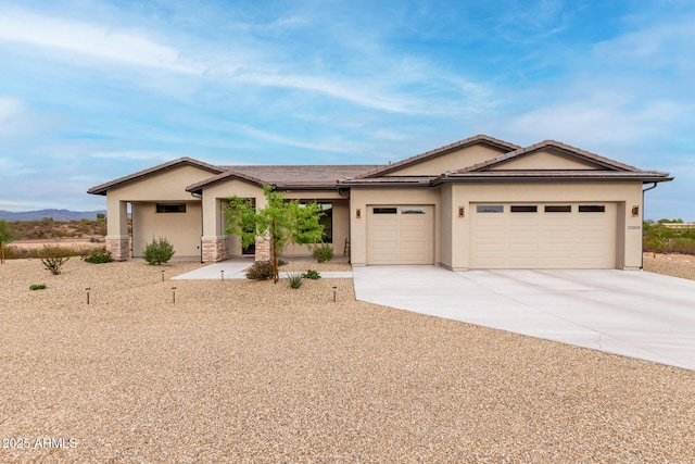 22050 W El Grande Trl, Wickenburg, AZ 85390 - single story home with a garage, stucco siding, stone siding, and concrete driveway