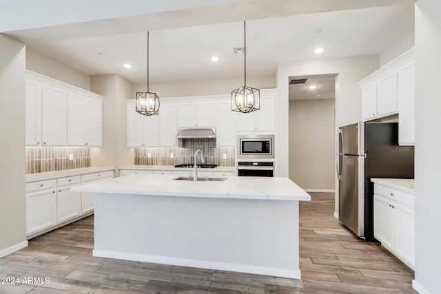 kitchen featuring white cabinetry, an island with sink, and light hardwood / wood-style flooring