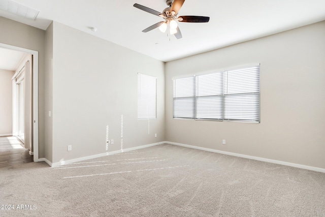 unfurnished room featuring light carpet and ceiling fan