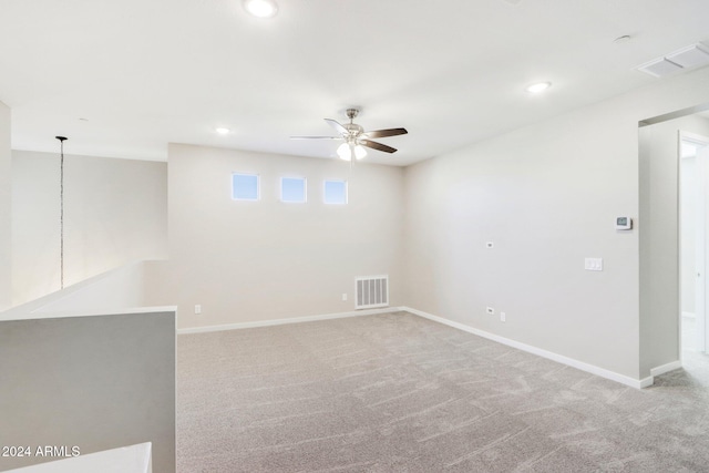 carpeted spare room with ceiling fan