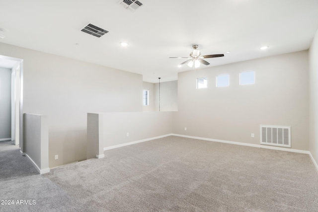 carpeted empty room featuring ceiling fan