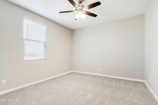 carpeted empty room featuring ceiling fan