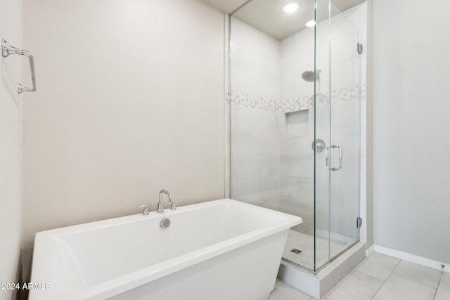 bathroom featuring tile patterned flooring and shower with separate bathtub