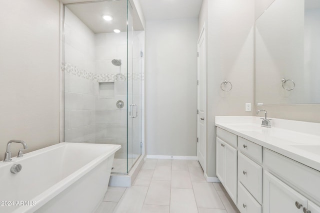 bathroom with tile patterned floors, vanity, and separate shower and tub