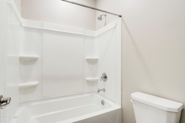 bathroom featuring shower / bathing tub combination and toilet