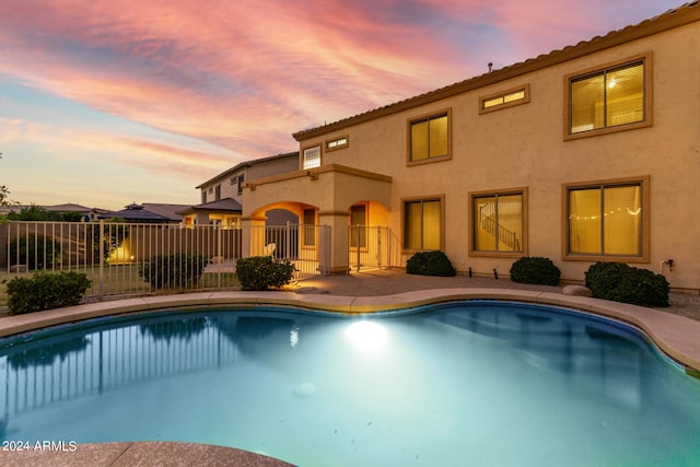 view of pool at dusk