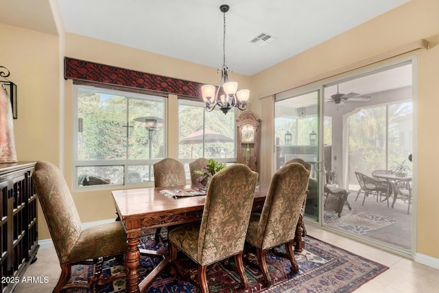 tiled dining space featuring a wealth of natural light and a chandelier