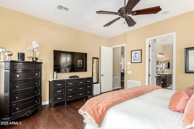 bedroom with connected bathroom, dark hardwood / wood-style flooring, and sink