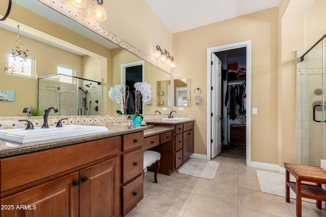 bathroom with an enclosed shower, vanity, and tile patterned flooring