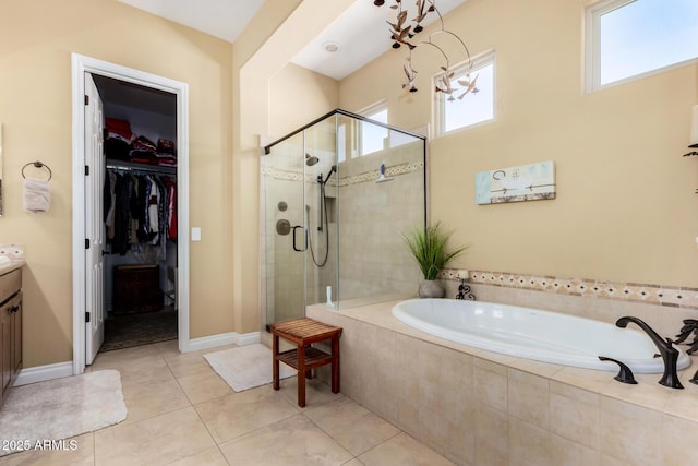 bathroom featuring a healthy amount of sunlight, separate shower and tub, tile patterned flooring, and vanity