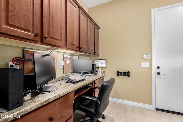 office space featuring light tile patterned floors and built in desk