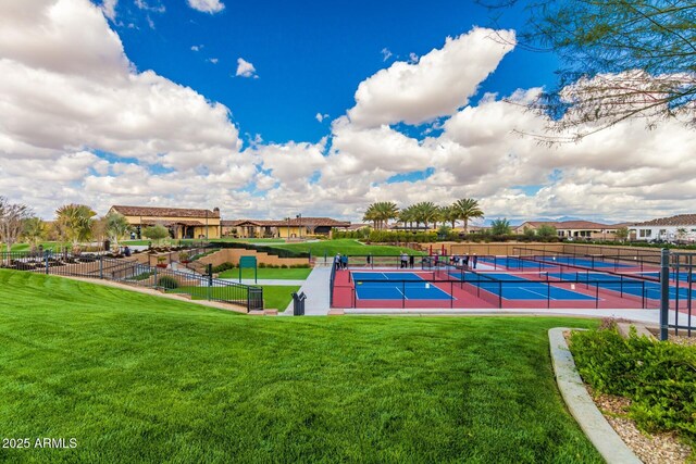 exterior space featuring tennis court and a lawn