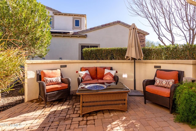 view of patio / terrace with an outdoor living space with a fire pit