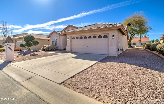 view of front of property with driveway, a tiled roof, and stucco siding