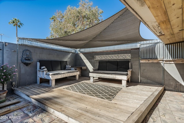 wooden terrace with an outdoor hangout area