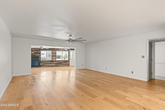 unfurnished living room featuring light hardwood / wood-style floors and ceiling fan