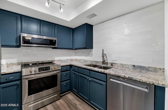 1075 E Chandler Blvd Unit 210, Chandler, AZ 85225 - kitchen with appliances with stainless steel finishes, blue cabinetry, dark wood-style floors, and light stone counters