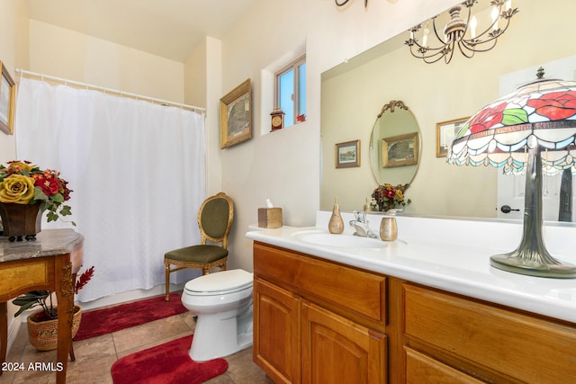 bathroom with vanity, a chandelier, toilet, and tile patterned floors