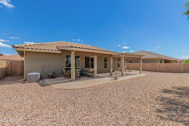 back of property featuring cooling unit, a patio area, and a pergola