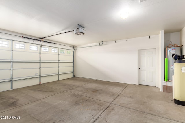 garage with a garage door opener, water heater, and gas water heater