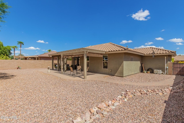 rear view of property with a pergola and a patio area