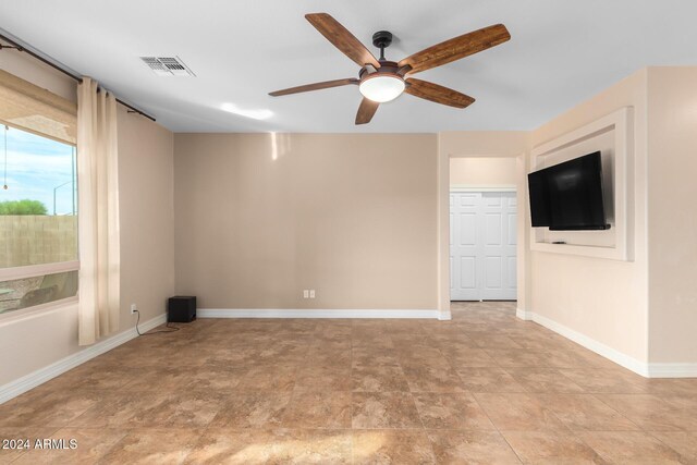 living room with ceiling fan and light tile patterned floors