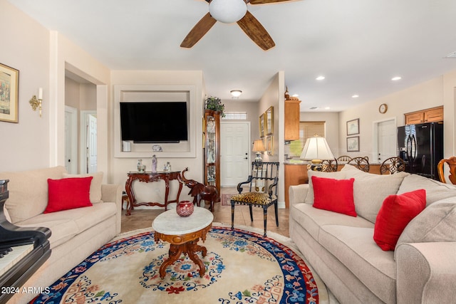 living room with hardwood / wood-style flooring and ceiling fan