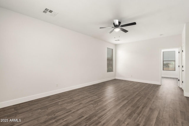 unfurnished room with dark hardwood / wood-style flooring and ceiling fan
