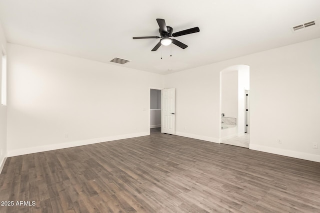 unfurnished room with ceiling fan and dark hardwood / wood-style floors