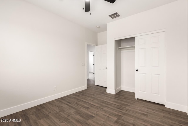 unfurnished bedroom with dark hardwood / wood-style floors, ceiling fan, and a closet