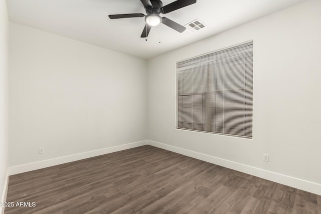 unfurnished room with ceiling fan and dark hardwood / wood-style flooring