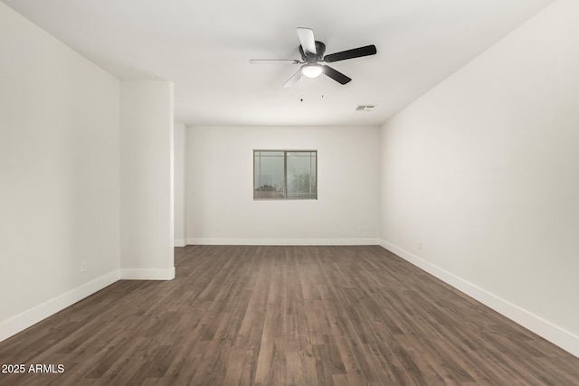 unfurnished room featuring dark wood-type flooring and ceiling fan