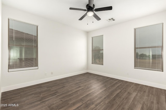 spare room with dark hardwood / wood-style floors and ceiling fan