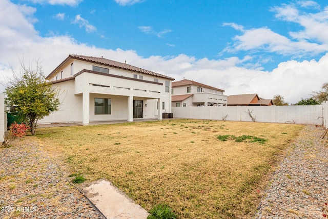 back of property with a balcony, a yard, and central AC unit
