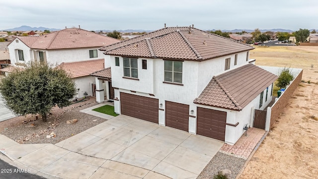 view of front of property with a garage and a mountain view