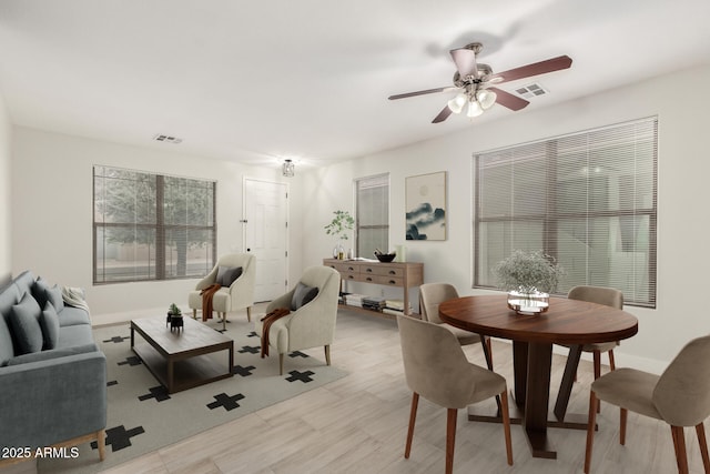 living room featuring light wood-type flooring and ceiling fan