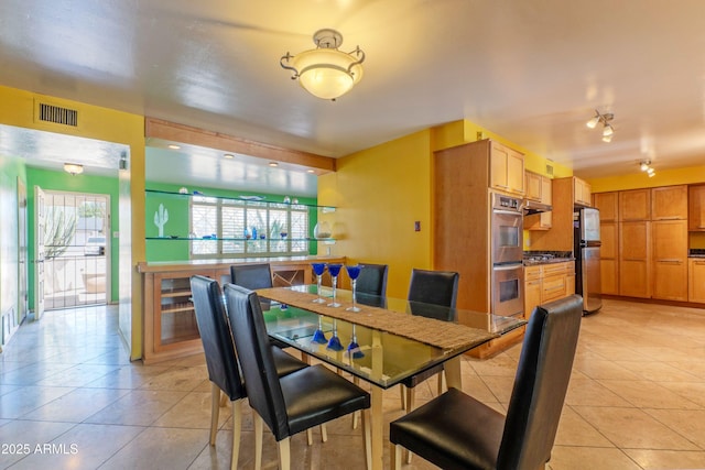 dining area with light tile patterned flooring and visible vents