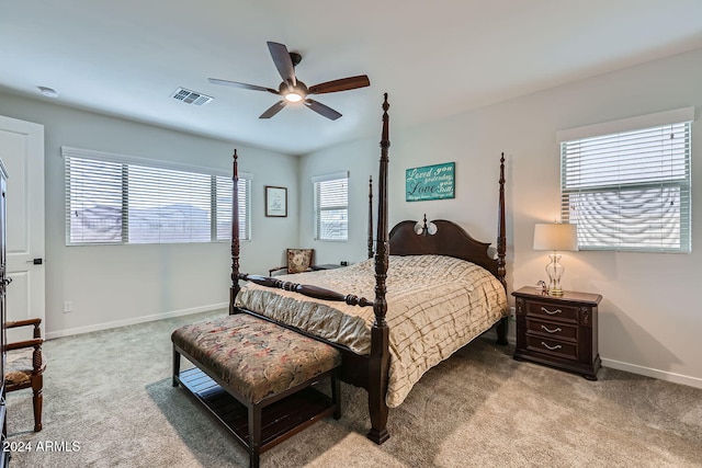 carpeted bedroom with ceiling fan and multiple windows